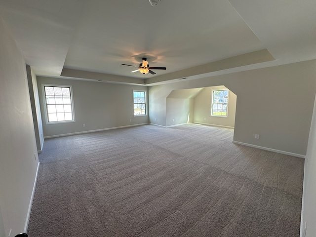 bonus room with ceiling fan and carpet