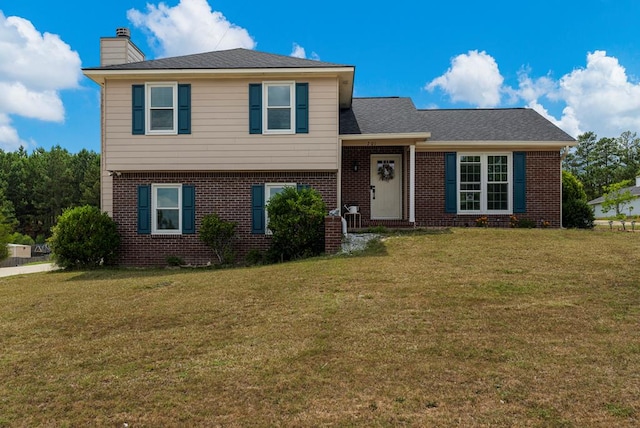 701 Crestline Dr, Columbus, GA 31907 - split level home featuring brick siding, a chimney, and a front yard