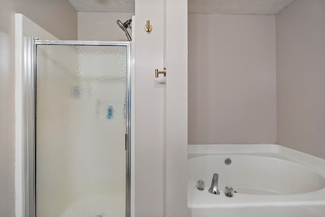 701 Crestline Dr, Columbus, GA 31907 - bathroom with a shower stall, a bath, and a textured ceiling