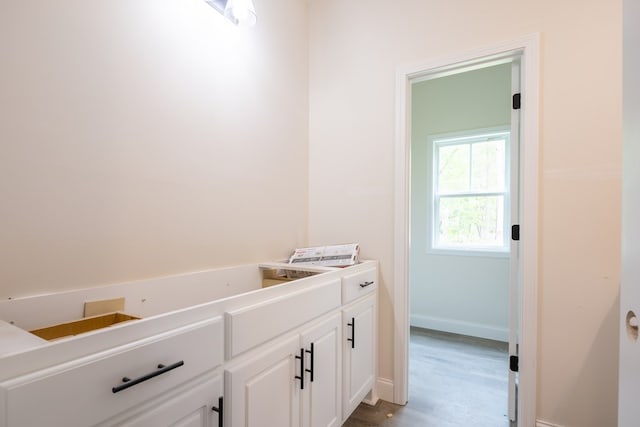 bathroom featuring wood finished floors and baseboards