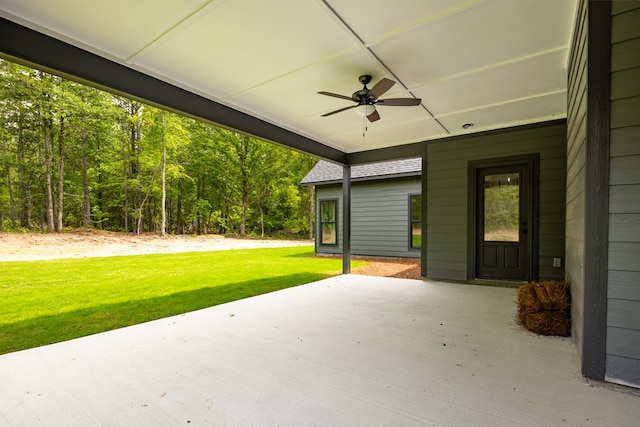 view of patio / terrace featuring ceiling fan and a wooded view
