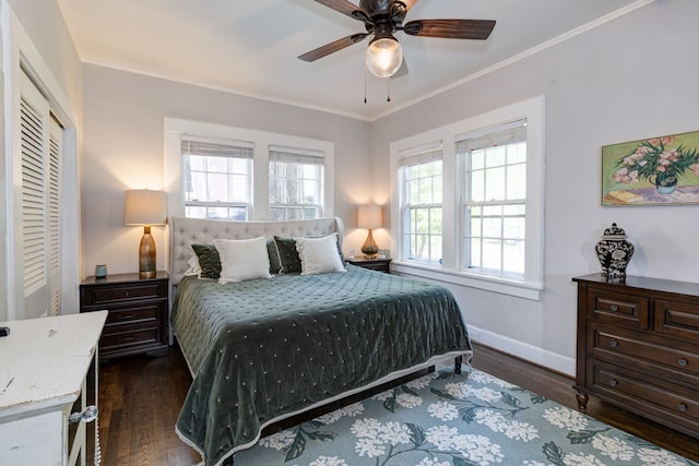bedroom featuring dark wood finished floors, baseboards, crown molding, and ceiling fan