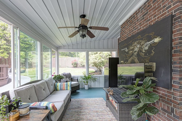sunroom / solarium featuring ceiling fan and outdoor lounge area
