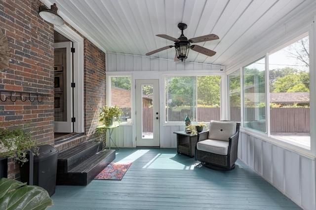 sunroom / solarium featuring ceiling fan