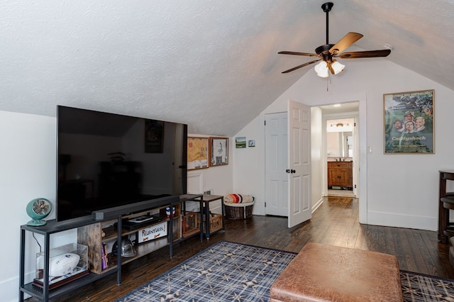 living room featuring lofted ceiling, baseboards, a ceiling fan, and wood finished floors