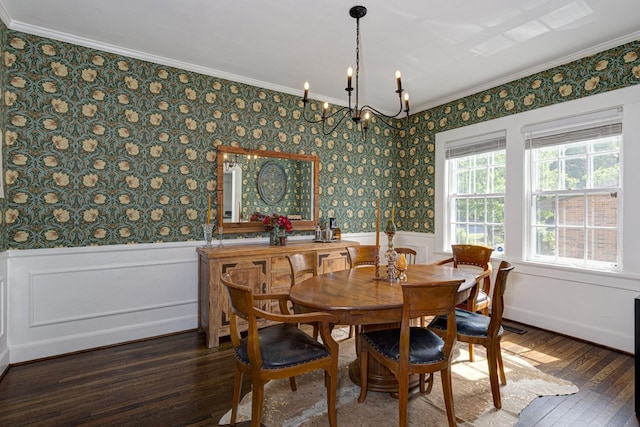 dining area featuring a wainscoted wall, wood finished floors, and ornamental molding