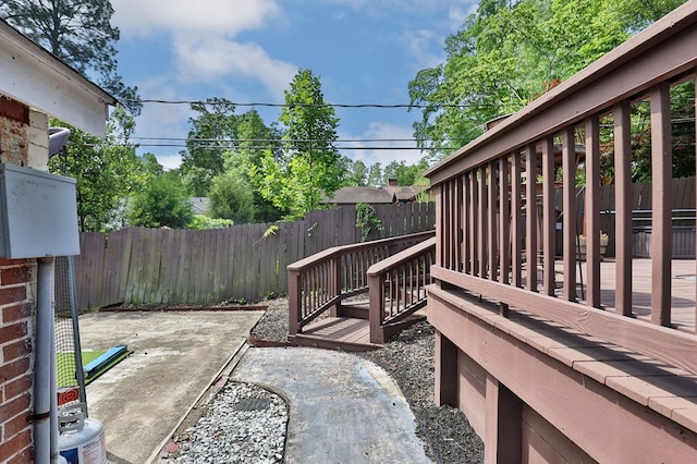 view of patio featuring a fenced backyard and a deck