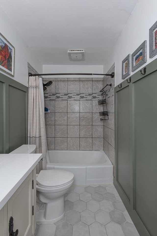 full bath featuring shower / bath combo, tile patterned floors, vanity, toilet, and visible vents