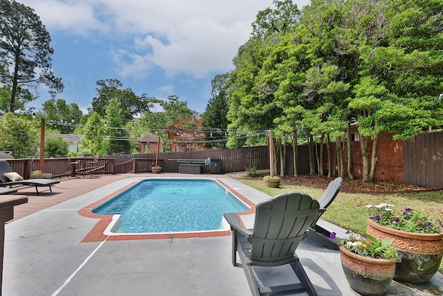 view of pool with a wooden deck, a fenced backyard, and a fenced in pool