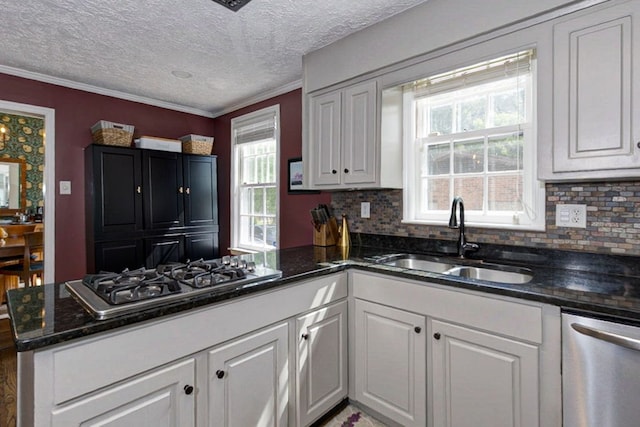kitchen featuring decorative backsplash, a sink, white cabinetry, and appliances with stainless steel finishes