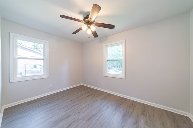 empty room with hardwood / wood-style flooring and ceiling fan