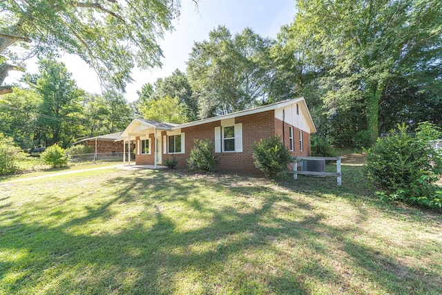 ranch-style home featuring a front yard and central air condition unit