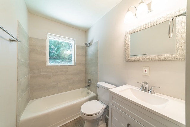 full bathroom with toilet, vanity, tiled shower / bath combo, and hardwood / wood-style flooring