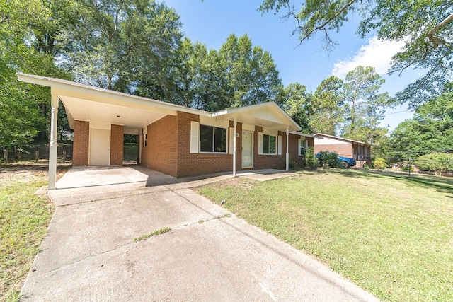 single story home with a porch, a front yard, and a carport