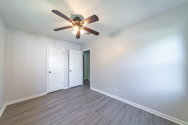 unfurnished bedroom featuring ceiling fan and hardwood / wood-style floors