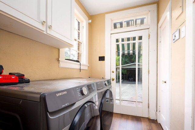 laundry room with cabinet space, wood finished floors, and independent washer and dryer