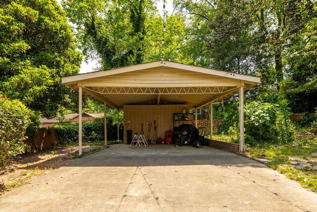 view of car parking featuring driveway and fence