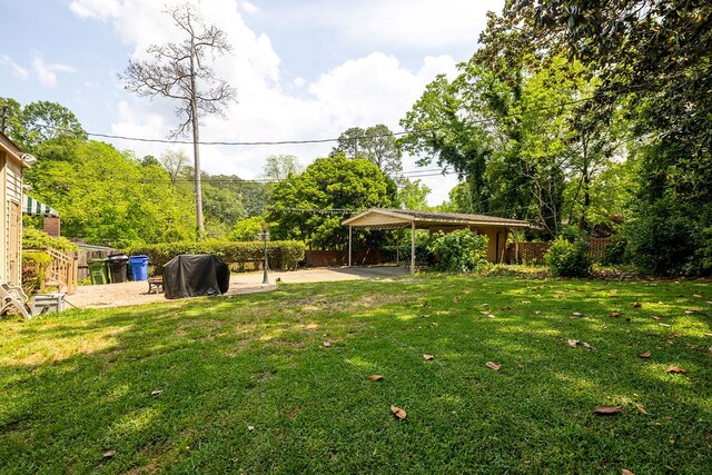 view of yard featuring fence and a patio
