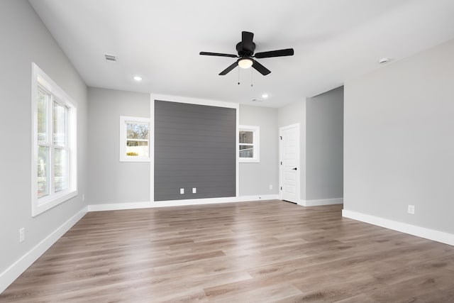 unfurnished room with ceiling fan and light hardwood / wood-style flooring