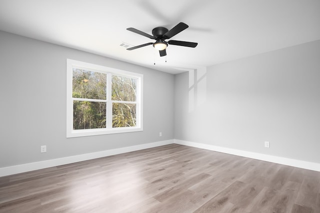 empty room with light hardwood / wood-style flooring and ceiling fan