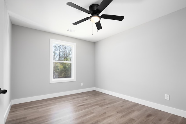 spare room with ceiling fan and light hardwood / wood-style flooring