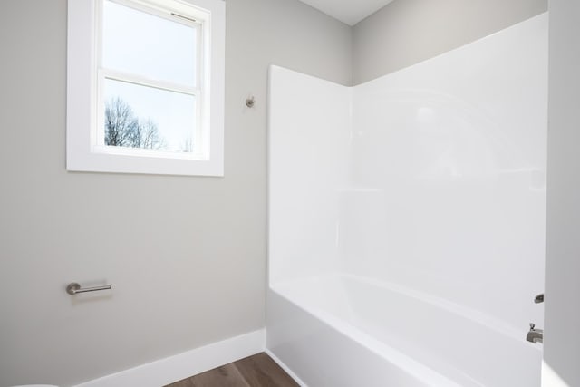 bathroom featuring hardwood / wood-style floors and a bathtub