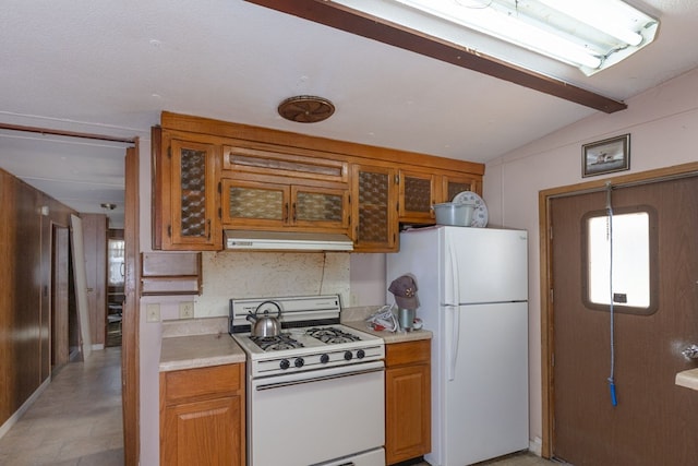 kitchen featuring white appliances, lofted ceiling with beams, and range hood