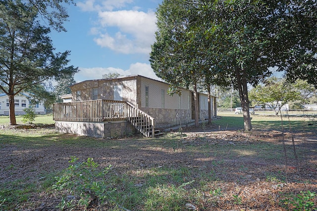 view of home's exterior featuring a wooden deck