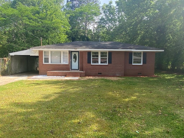 ranch-style house featuring a front yard and a carport