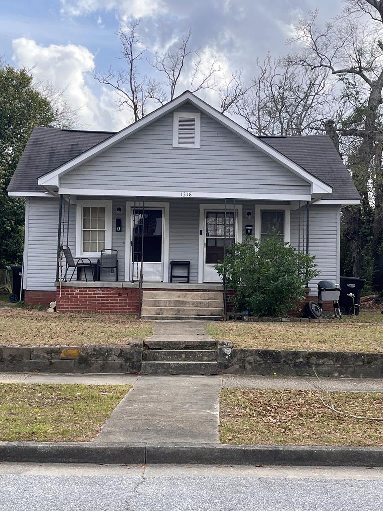 bungalow-style house featuring covered porch and roof with shingles