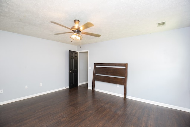 unfurnished room featuring baseboards, wood finished floors, and a ceiling fan