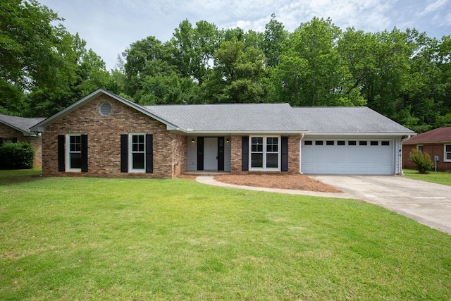 ranch-style house featuring concrete driveway, a garage, a front yard, and brick siding