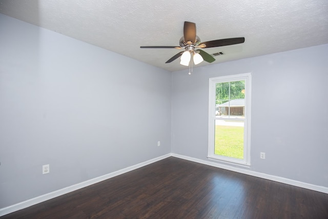 spare room with baseboards, dark wood-style floors, a ceiling fan, and a textured ceiling