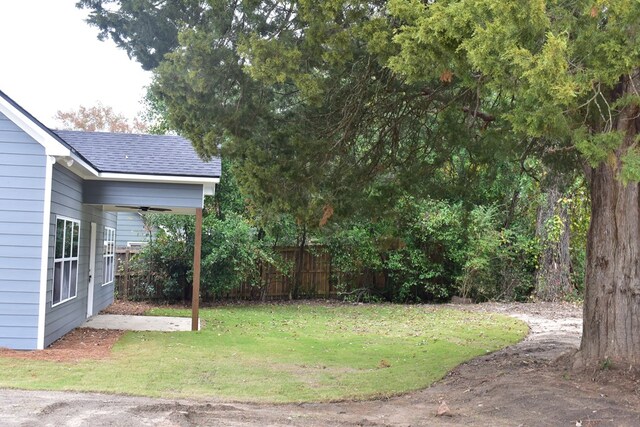 rear view of house featuring a yard and a patio