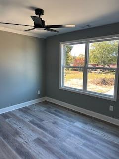 unfurnished living room featuring a stone fireplace, ceiling fan, and dark hardwood / wood-style flooring