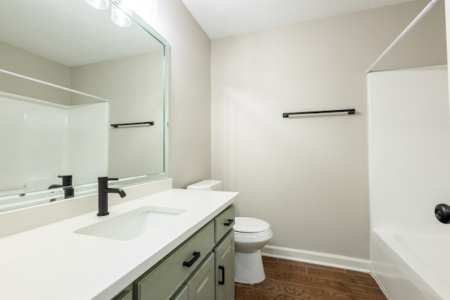full bathroom with vanity, toilet, baseboards, bathing tub / shower combination, and wood finished floors
