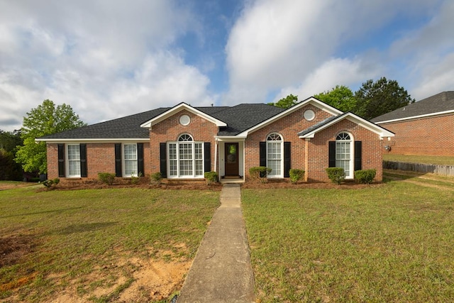 ranch-style house with brick siding and a front lawn