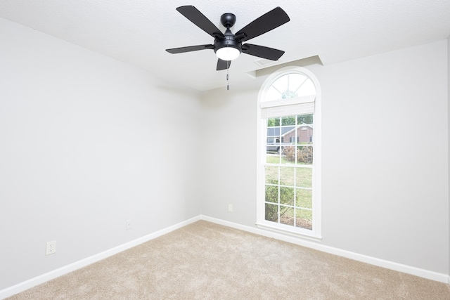 spare room with baseboards, carpet flooring, and ceiling fan