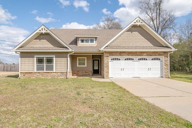 craftsman-style home with fence, driveway, an attached garage, a front lawn, and stone siding