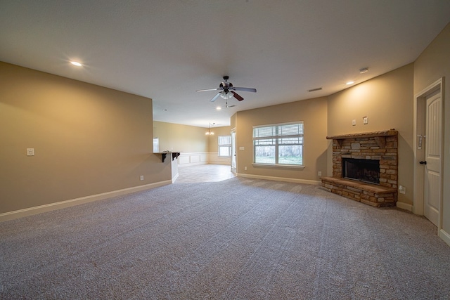 unfurnished living room featuring visible vents, a ceiling fan, recessed lighting, carpet, and a stone fireplace