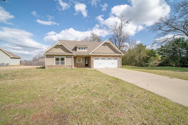 craftsman-style house featuring fence, driveway, a front lawn, a garage, and stone siding