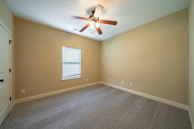 carpeted empty room with visible vents, a ceiling fan, and baseboards