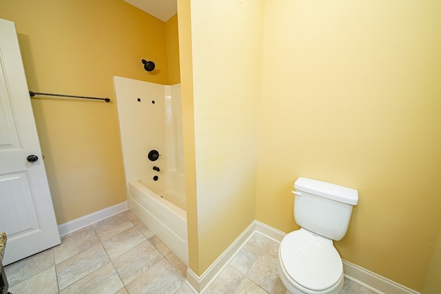 bathroom with toilet, baseboards, and shower / bath combination