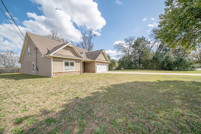 view of front of house with stone siding, an attached garage, driveway, and a front lawn