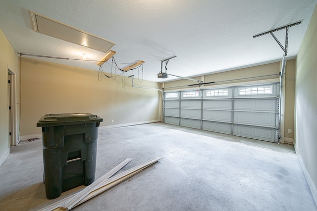 garage with a garage door opener and baseboards