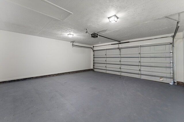 5437 Chatham Woods Ct, Columbus, GA 31907 - garage with a garage door opener and baseboards