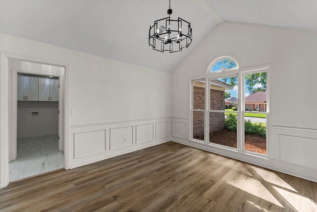 5437 Chatham Woods Ct, Columbus, GA 31907 - unfurnished dining area with a chandelier, a wainscoted wall, wood finished floors, high vaulted ceiling, and a decorative wall
