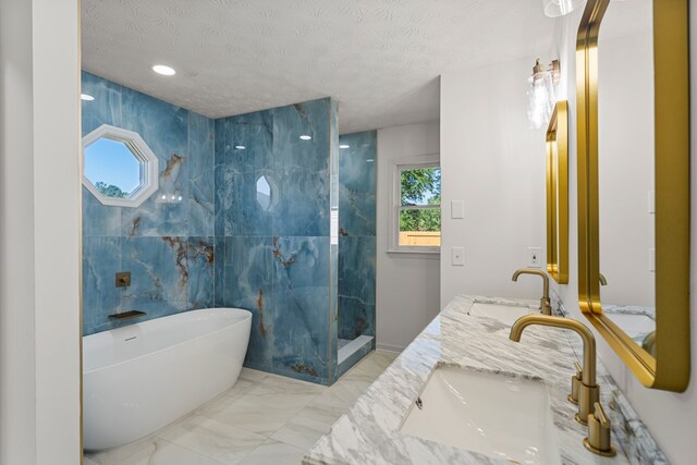 5437 Chatham Woods Ct, Columbus, GA 31907 - bathroom with a freestanding bath, double vanity, a walk in shower, a textured ceiling, and marble finish floors