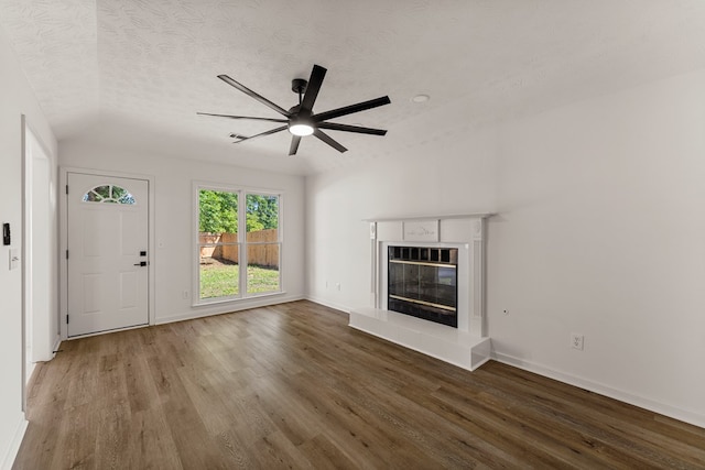 5437 Chatham Woods Ct, Columbus, GA 31907 - unfurnished living room with wood finished floors, a ceiling fan, a glass covered fireplace, and a textured ceiling