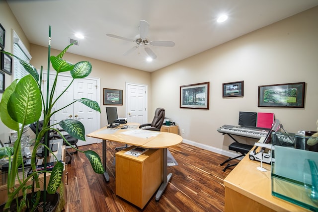 home office with ceiling fan and dark hardwood / wood-style flooring